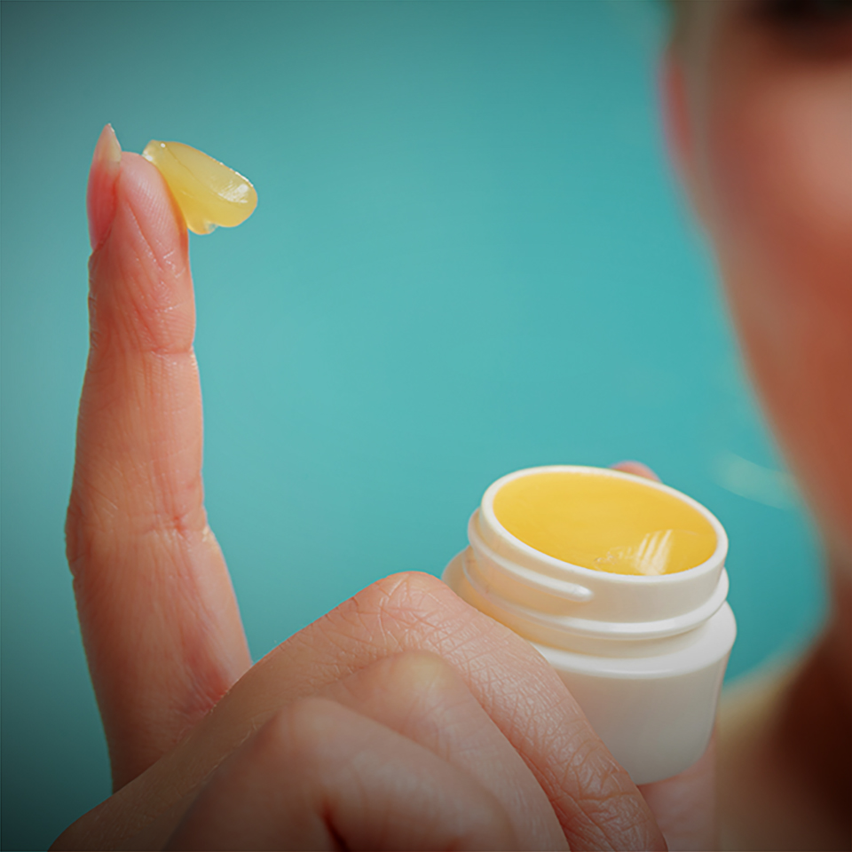 woman applying balsam for lips