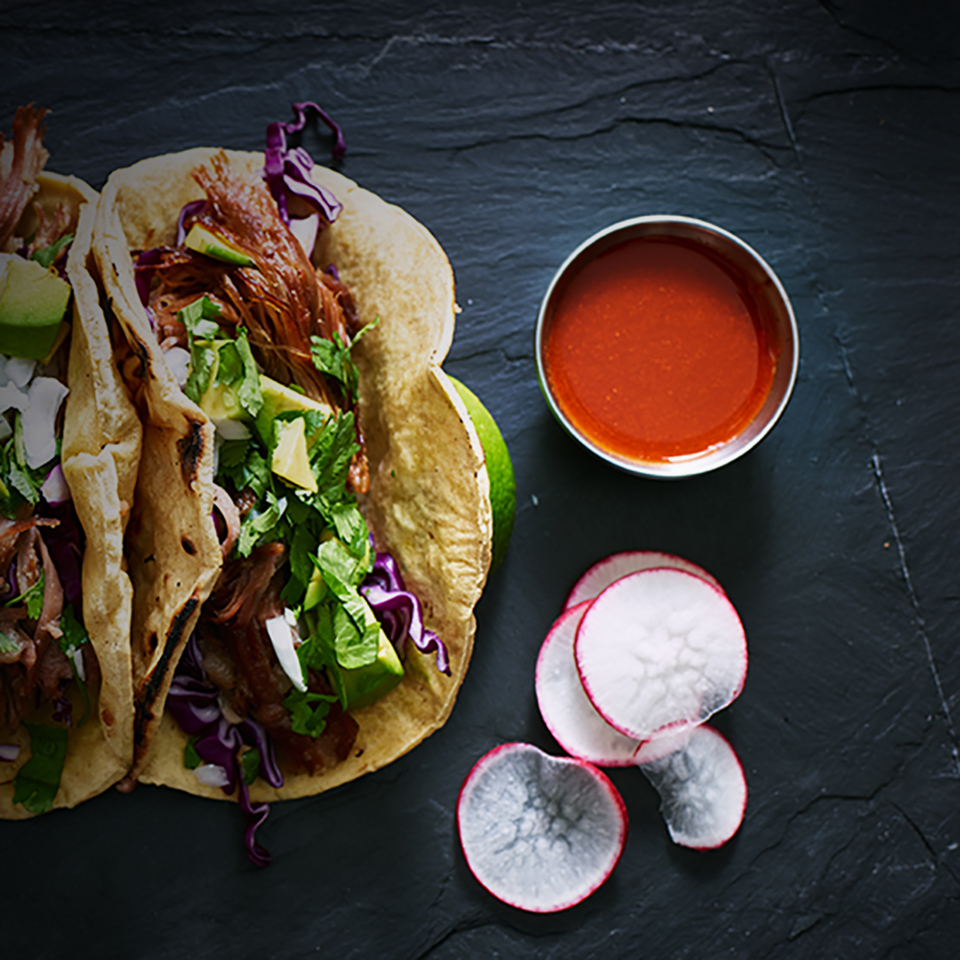 three mexican pork carnitas tacos flat lay composition