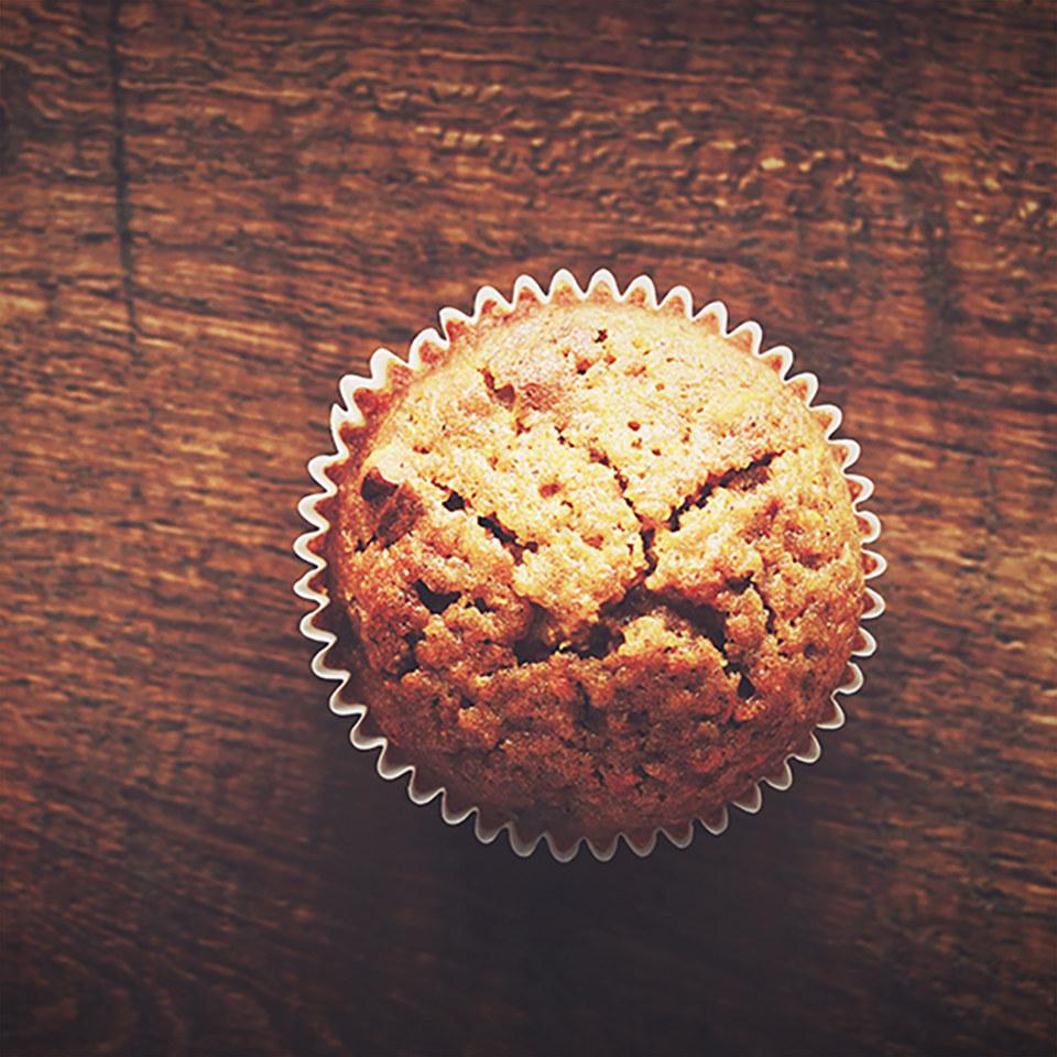 Homemade carrot muffin with empty space on brown wooden backgrou